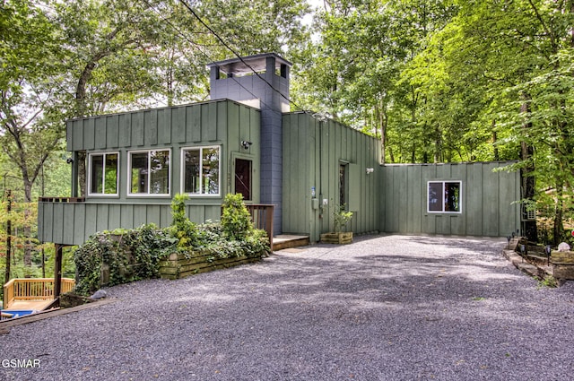 1125 Tanrac Trl, Gatlinburg, TN 37738 - view of front of property featuring board and batten siding, gravel driveway, and a chimney