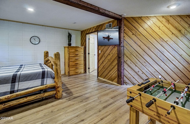 1125 Tanrac Trl, Gatlinburg, TN 37738 - bedroom featuring beam ceiling, wood finished floors, visible vents, and wooden walls