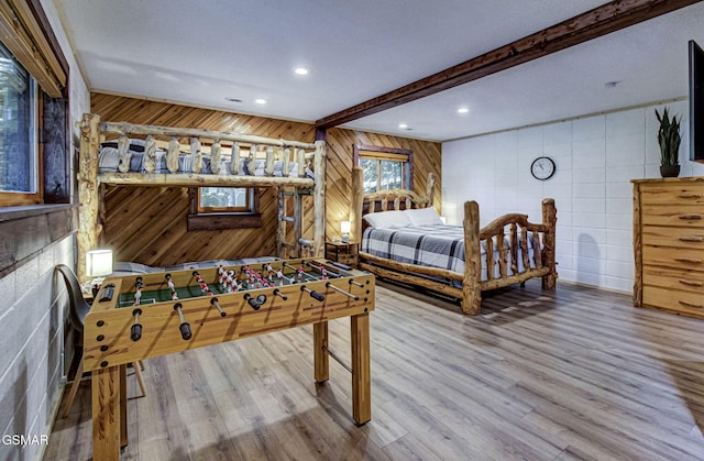 1125 Tanrac Trl, Gatlinburg, TN 37738 - bedroom with recessed lighting, wooden walls, wood finished floors, tile walls, and beam ceiling