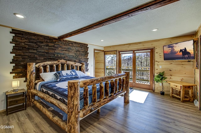 1125 Tanrac Trl, Gatlinburg, TN 37738 - bedroom with wood finished floors, a textured ceiling, beam ceiling, and access to outside