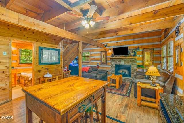 1918 Charles Lewis Way, Sevierville, TN 37876 - dining space with wood walls, light wood-style floors, a wooden ceiling with exposed beams, a ceiling fan, and a stone fireplace