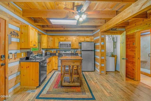 1918 Charles Lewis Way, Sevierville, TN 37876 - kitchen featuring appliances with stainless steel finishes, stacked washer / dryer, a ceiling fan, a wood ceiling with exposed beams, and light wood-style flooring