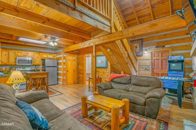 1918 Charles Lewis Way, Sevierville, TN 37876 - living room with wooden walls, a wooden ceiling with exposed beams, ceiling fan, light wood-type flooring, and stairway