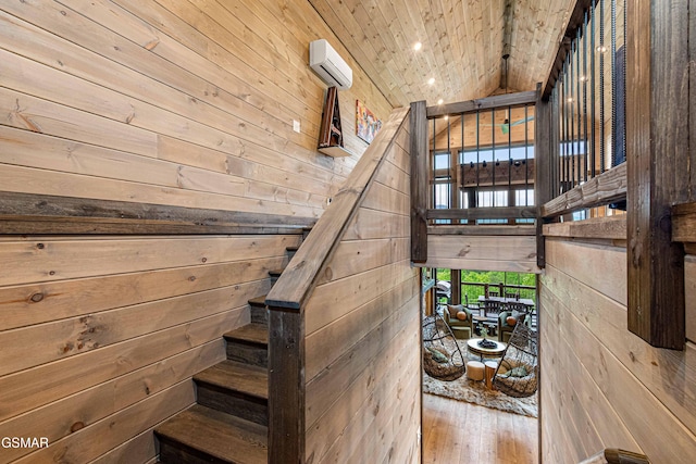 4408 Stackstone Rd, Sevierville, TN 37862 - staircase featuring wooden walls, a wall mounted air conditioner, hardwood / wood-style floors, wood ceiling, and recessed lighting