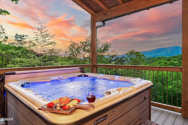 4408 Stackstone Rd, Sevierville, TN 37862 - deck at dusk featuring a hot tub and a mountain view