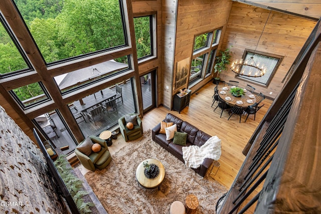 4408 Stackstone Rd, Sevierville, TN 37862 - living room featuring wooden walls, wood finished floors, and a chandelier