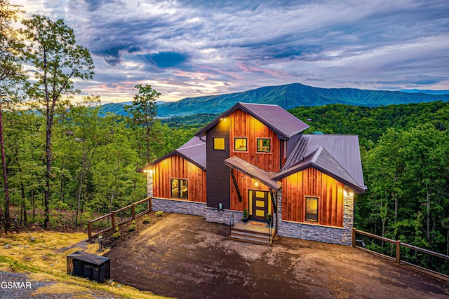 4408 Stackstone Rd, Sevierville, TN 37862 - view of front facade with stone siding, a mountain view, board and batten siding, and a metal roof