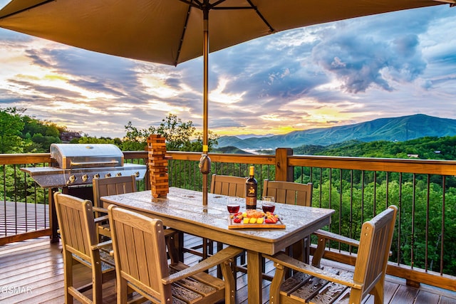 4408 Stackstone Rd, Sevierville, TN 37862 - deck at dusk with a mountain view and outdoor dining area