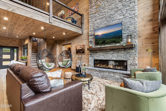 4408 Stackstone Rd, Sevierville, TN 37862 - living area with a stone fireplace, recessed lighting, wood walls, and wooden ceiling