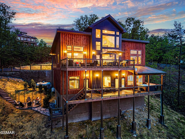 4408 Stackstone Rd, Sevierville, TN 37862 - back of house at dusk featuring a deck