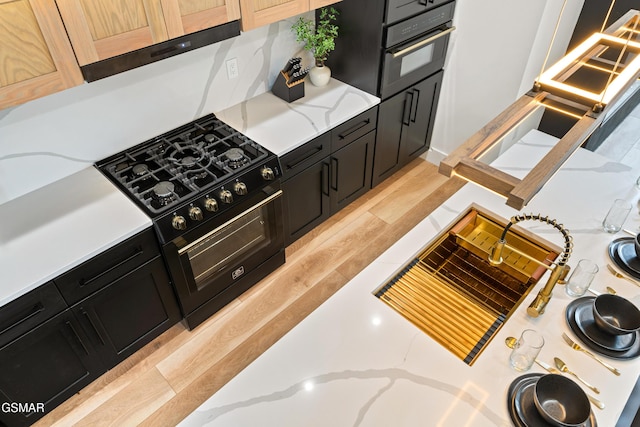 1163 Reedmont Way, Sevierville, TN 37876 - kitchen with dark cabinetry, black appliances, and light stone countertops