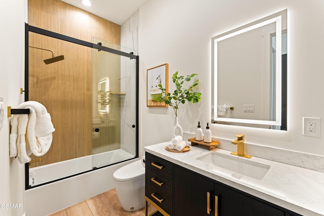 1163 Reedmont Way, Sevierville, TN 37876 - full bathroom featuring vanity, shower / bath combination with glass door, and wood finished floors