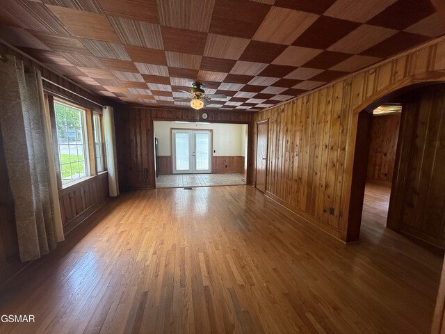 3380 Grassy Fork Rd, Hartford, TN 37753 - spare room with wooden walls, a ceiling fan, light wood-style flooring, and arched walkways