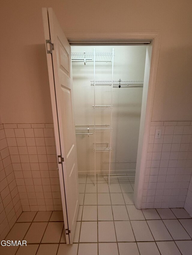 3380 Grassy Fork Rd, Hartford, TN 37753 - bathroom featuring tile patterned floors, tile walls, and a wainscoted wall