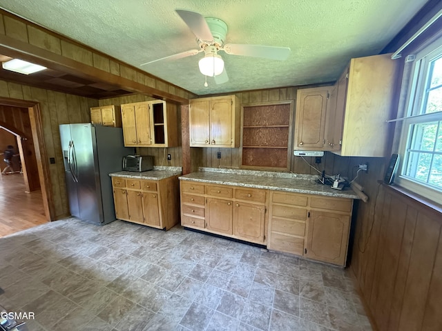 3380 Grassy Fork Rd, Hartford, TN 37753 - kitchen featuring open shelves, wooden walls, stainless steel fridge with ice dispenser, healthy amount of natural light, and ceiling fan