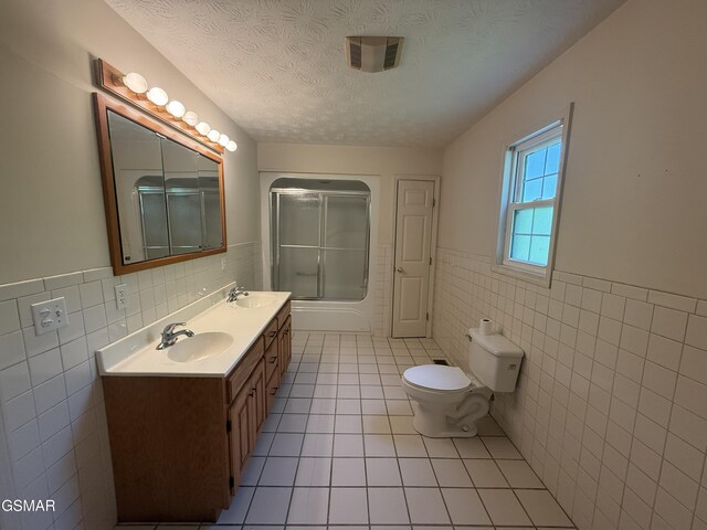 3380 Grassy Fork Rd, Hartford, TN 37753 - full bath featuring tile walls, wainscoting, tile patterned flooring, toilet, and double vanity
