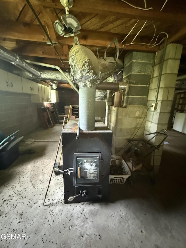 3380 Grassy Fork Rd, Hartford, TN 37753 - below grade area featuring concrete block wall and a wood stove
