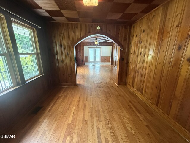 3380 Grassy Fork Rd, Hartford, TN 37753 - hall with wooden walls, arched walkways, healthy amount of natural light, and light wood-style floors