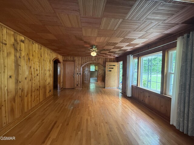 3380 Grassy Fork Rd, Hartford, TN 37753 - empty room with arched walkways, wooden walls, ceiling fan, and wood finished floors