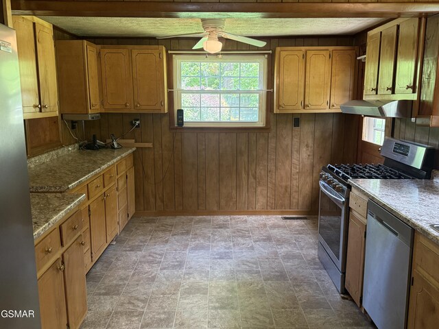 3380 Grassy Fork Rd, Hartford, TN 37753 - kitchen featuring appliances with stainless steel finishes, ceiling fan, healthy amount of natural light, wood walls, and baseboards