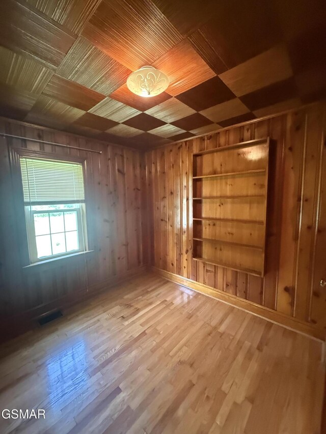 3380 Grassy Fork Rd, Hartford, TN 37753 - spare room with wooden walls, built in shelves, and wood finished floors