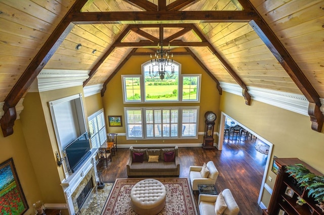 living room with beamed ceiling, an inviting chandelier, and wooden ceiling