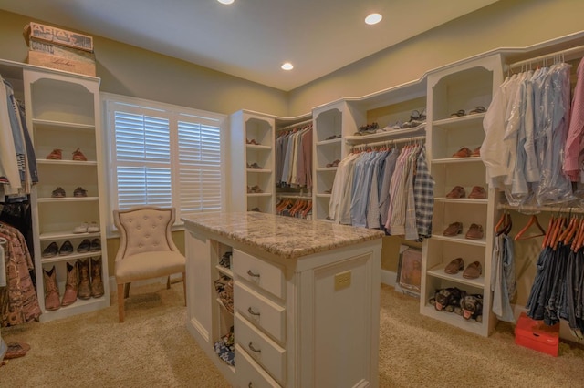 spacious closet featuring light colored carpet