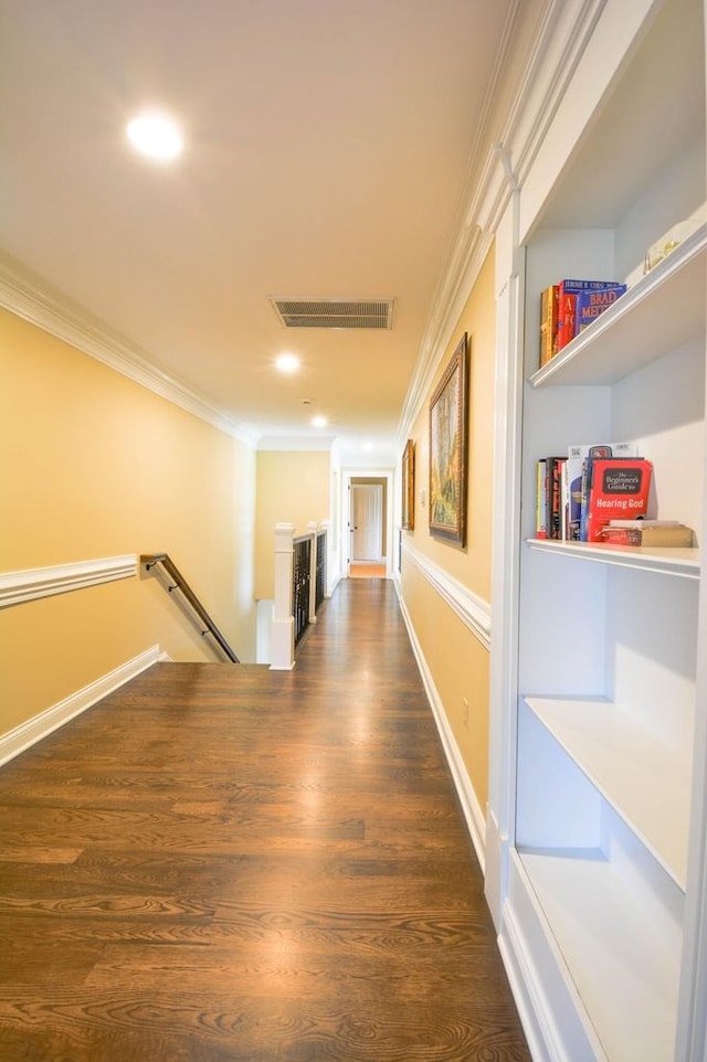 hallway with dark hardwood / wood-style floors and ornamental molding