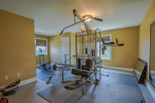 exercise room with a textured ceiling