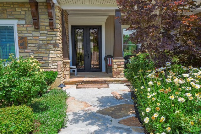 view of exterior entry featuring french doors