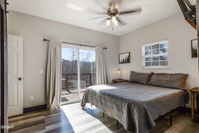 bedroom featuring baseboards, wood finished floors, a ceiling fan, and access to exterior