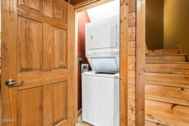 washroom featuring stacked washer / dryer