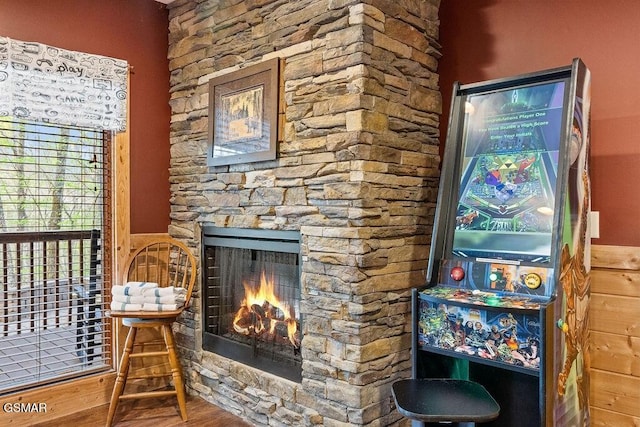 details featuring hardwood / wood-style flooring and a stone fireplace