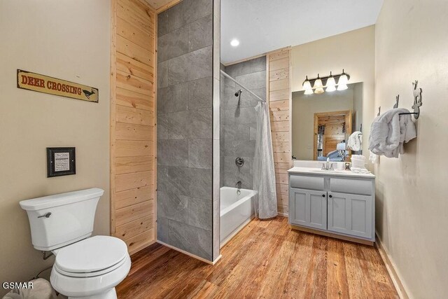 full bathroom with toilet, vanity, shower / bath combination with curtain, and hardwood / wood-style flooring