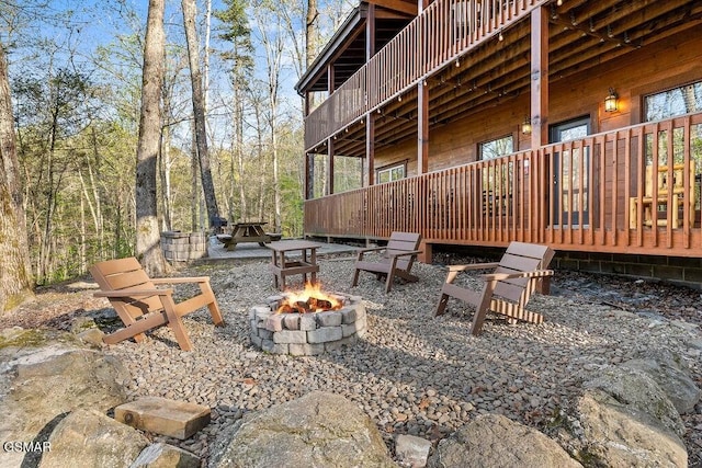 view of yard with an outdoor fire pit and a wooden deck