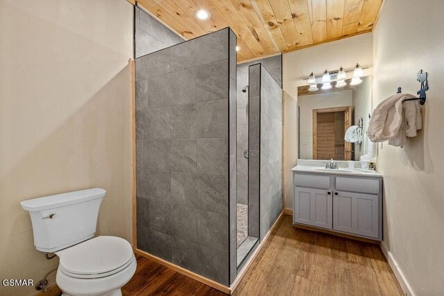 bathroom featuring vanity, a shower, wooden ceiling, toilet, and wood-type flooring