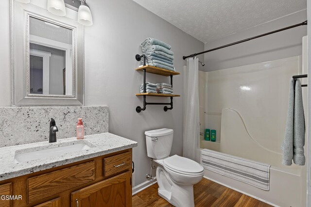 3225 Laurelwood Ave, Sevierville, TN 37862 - full bath with wood finished floors, toilet, vanity, baseboards, and a textured ceiling