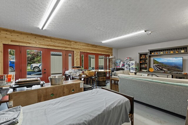 3225 Laurelwood Ave, Sevierville, TN 37862 - bedroom with wooden walls, a textured ceiling, and french doors