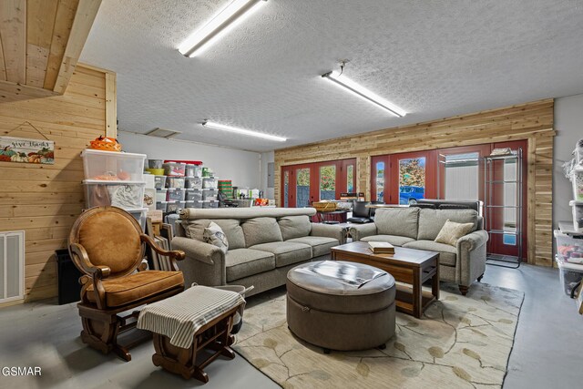 3225 Laurelwood Ave, Sevierville, TN 37862 - living room with wood walls, a textured ceiling, visible vents, and finished concrete flooring