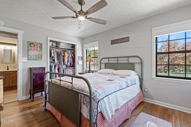 3225 Laurelwood Ave, Sevierville, TN 37862 - bedroom with wood finished floors, a closet, baseboards, a textured ceiling, and ceiling fan