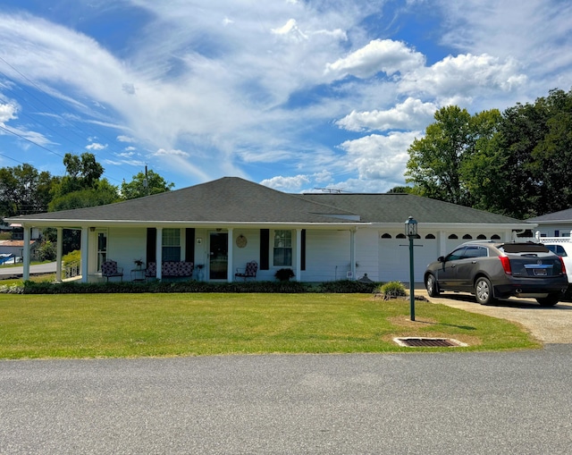 ranch-style house featuring a porch, a garage, and a front yard