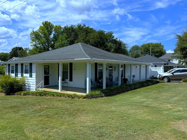 single story home featuring covered porch and a front yard