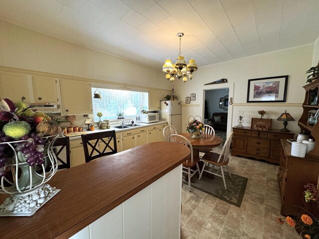 dining space with a chandelier and sink