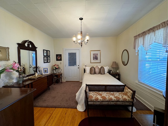 bedroom with a notable chandelier and light hardwood / wood-style floors