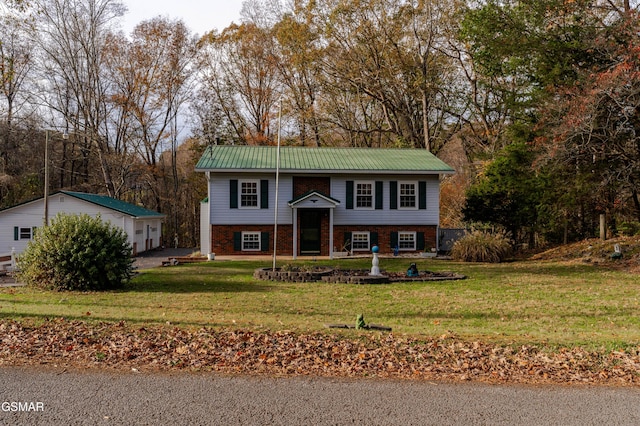 raised ranch with a front yard
