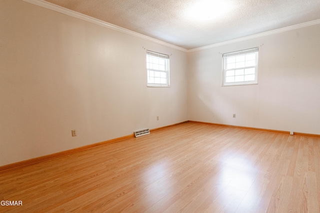 empty room with light wood-type flooring, crown molding, and a healthy amount of sunlight
