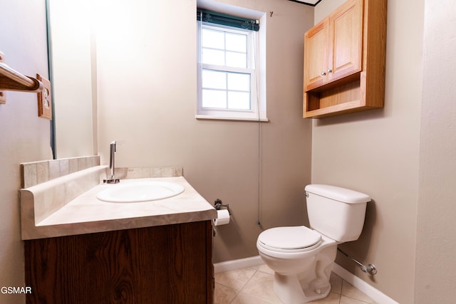 bathroom featuring tile patterned flooring, vanity, and toilet