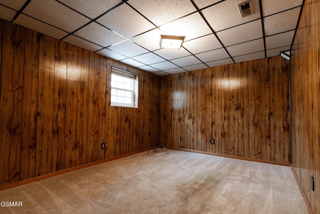 basement featuring carpet floors and wood walls