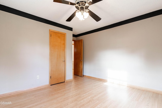 empty room with ceiling fan and light wood-type flooring