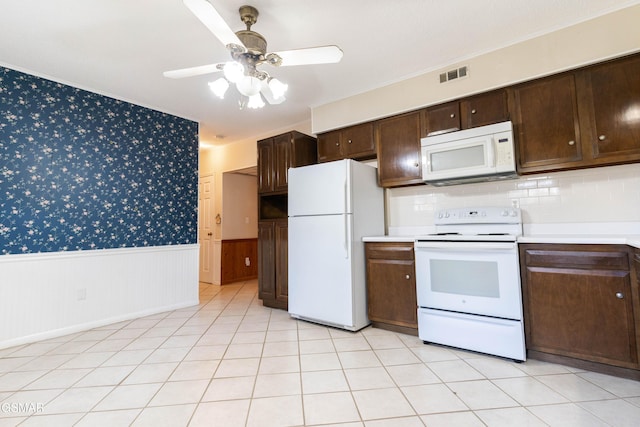 kitchen with ceiling fan, dark brown cabinets, light tile patterned floors, and white appliances